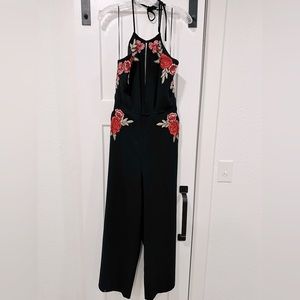 Black Gianni Bini rose jumpsuit with cutouts.